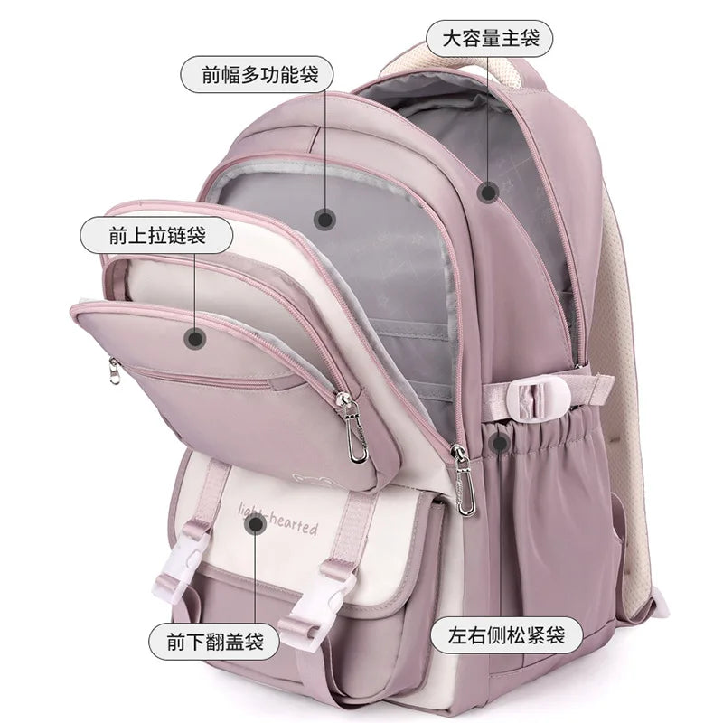 Sac à dos scolaire patchwork en nylon, avec poches fonctionnelles et coloré, parfait pour enfants.