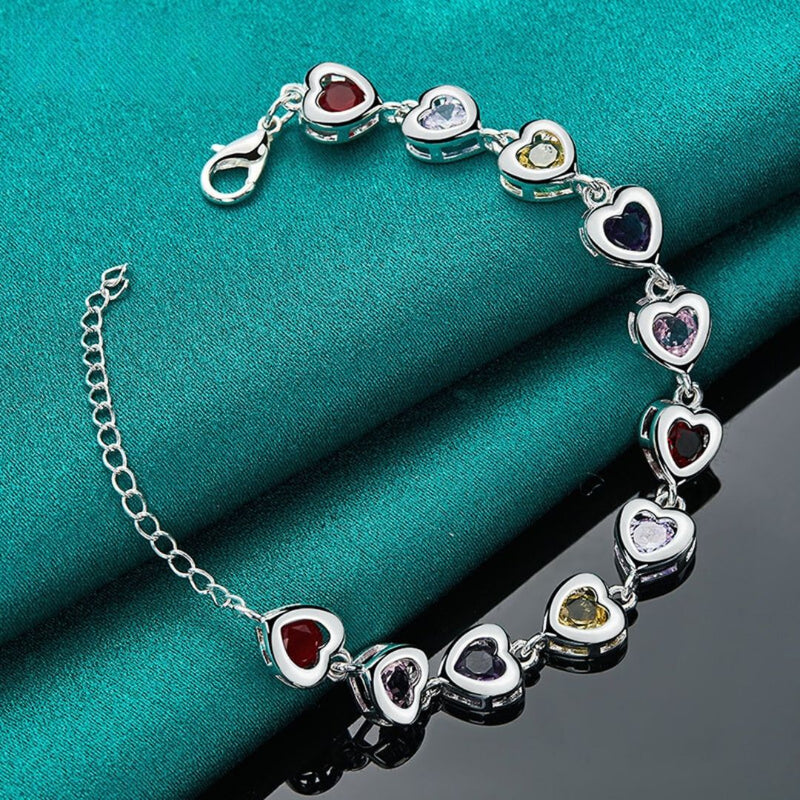 Silver plated bracelet with heart-shaped motifs inlaid with multi-colored zircons