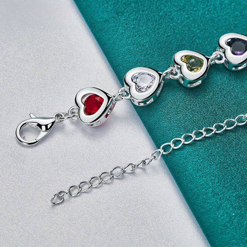 Silver plated bracelet with heart-shaped motifs inlaid with multi-colored zircons
