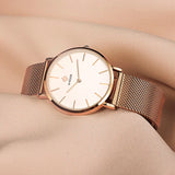 Montre femme WWOOR or rose avec cadran blanc, bracelet maille milanaise, packaging inclus