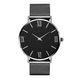 Montre femme élégante argentée avec cadran noir et index argentés, bracelet maille milanaise