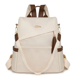 Sac à dos antivol femme en nylon beige avec pompon et détails marron