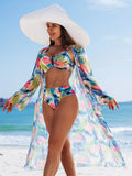 Femme en maillot de bain 3 pièces imprimé multicolore et kimono transparent, en pleine lumière du soleil