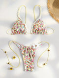 Bikini triangle orange vif, bas micro string, sur fond blanc avec fleurs