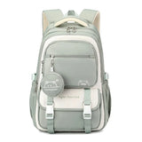 Sac à dos scolaire en nylon vert avec poches et design mignon pour enfants, parfait pour l'école.