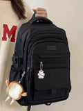 Sac à dos noir avec plusieurs poches et un accessoire mignon, idéal pour le lycée et le transport d'ordinateur.