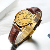 Montre OLEVS classique pour femme avec cadran doré et bracelet en cuir marron, vue de côté