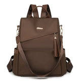 Sac à dos antivol femme en nylon marron avec pompon et bandoulière