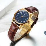 Montre OLEVS classique pour femme avec cadran blanc et bracelet en cuir marron, fermoir doré