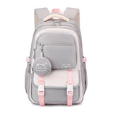 Sac à dos scolaire patchwork en nylon gris et rose avec motifs dessin animé et poche avant.