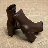 Bottines Chelsea marron vue de profil sur fond de journal