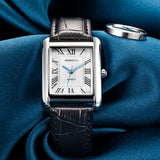 Montre femme rétro cadran carré argenté bracelet cuir noir détail sur tissu bleu