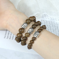 Bracelet en perles de bois avec tête de Bouddha