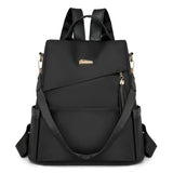 Sac à dos antivol femme en nylon noir avec pompon et bandoulière