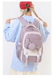 Sac à dos scolaire en nylon rose avec motif cartoon, parfait pour les enfants en style patchwork.