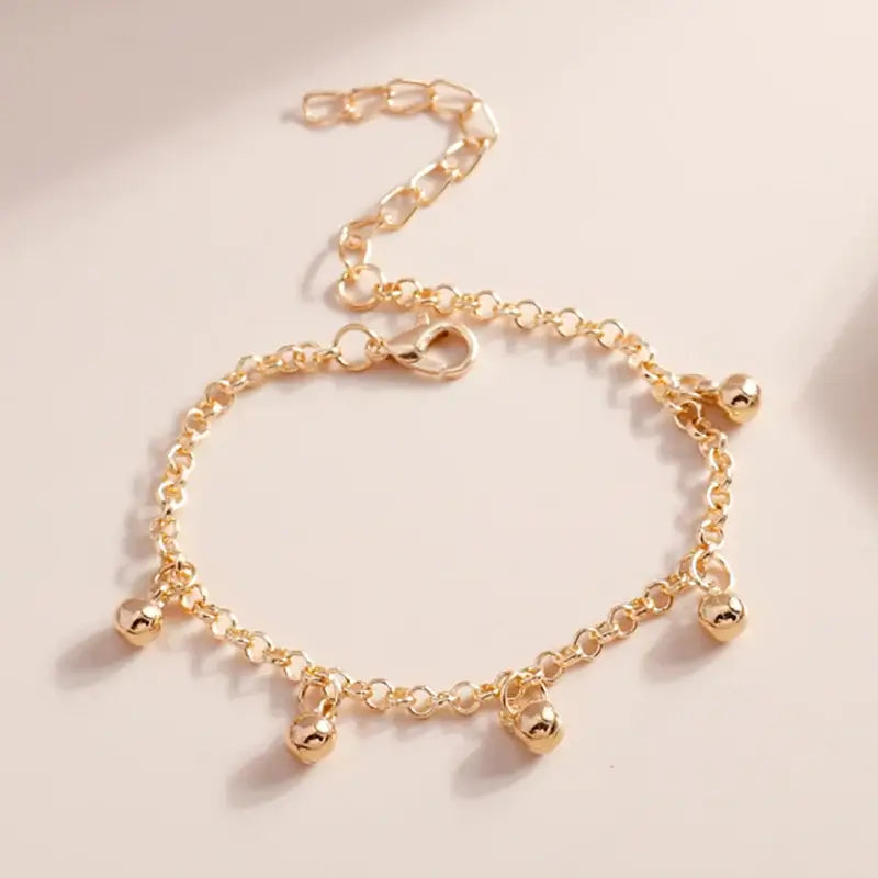 Pulsera de campana dorada Aihua: diseño elegante con campana colgante