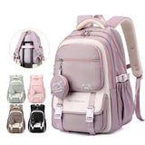 Sac à dos scolaire en nylon avec poches et design coloré, adapté aux enfants, styles uni et patchwork.