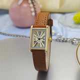Montre femme cadran doré chiffres romains, bracelet noir