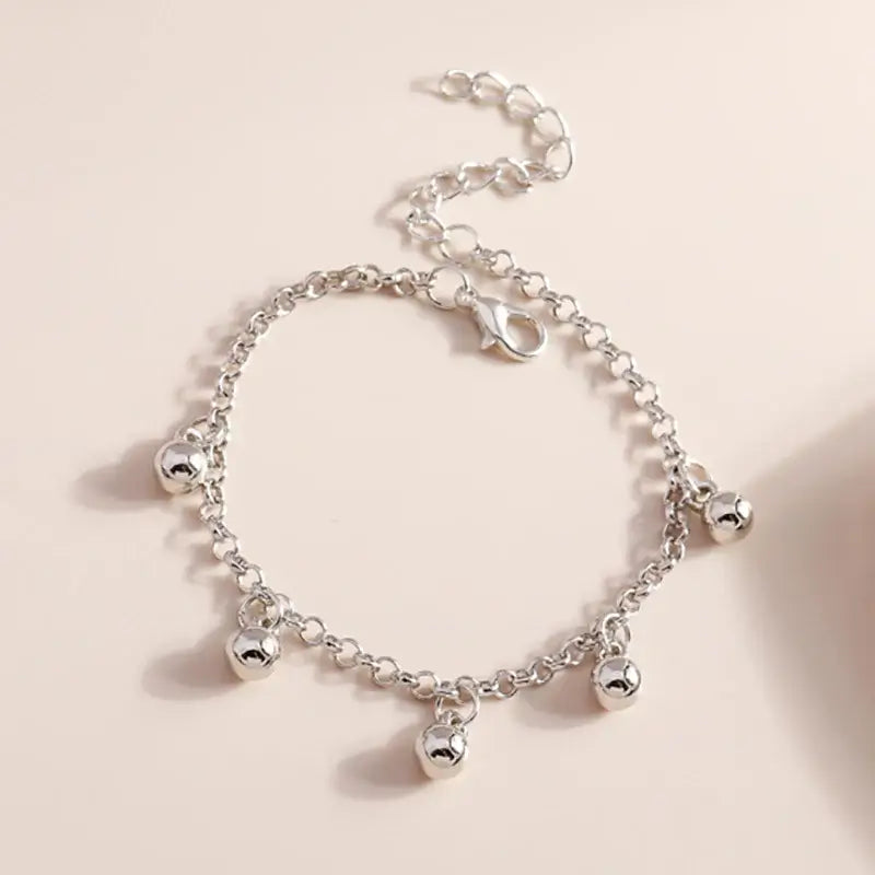 Pulsera de campana dorada Aihua: diseño elegante con campana colgante