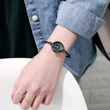 Montre bracelet dorée avec cadran blanc à chiffres romains et bracelet torsadé