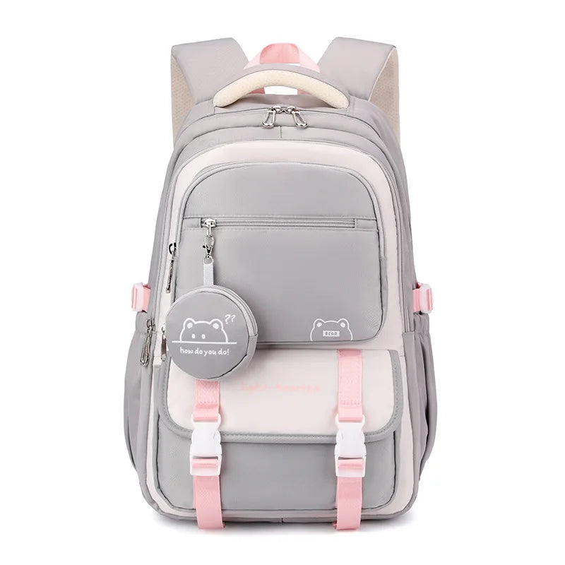Sac à dos scolaire patchwork en nylon gris et rose avec motifs dessin animé et poche avant.