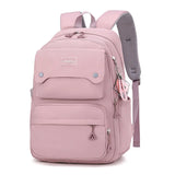 Sac à dos rose en nylon grande capacité avec bretelles réglables et poches pratiques pour filles.