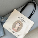 Sac fourre-tout en toile beige avec anses noires, imprimé 'Today is Milk Tea Happy Day' et illustration