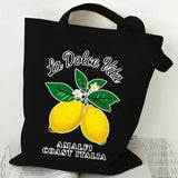 Sac en toile noir motif La Dolce Vita et citrons, sur fond blanc