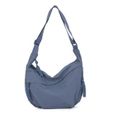 Sac hobo bandoulière femme couleur orange brûlé, gros plan sur le détail de la fermeture éclair et de la anse tressée