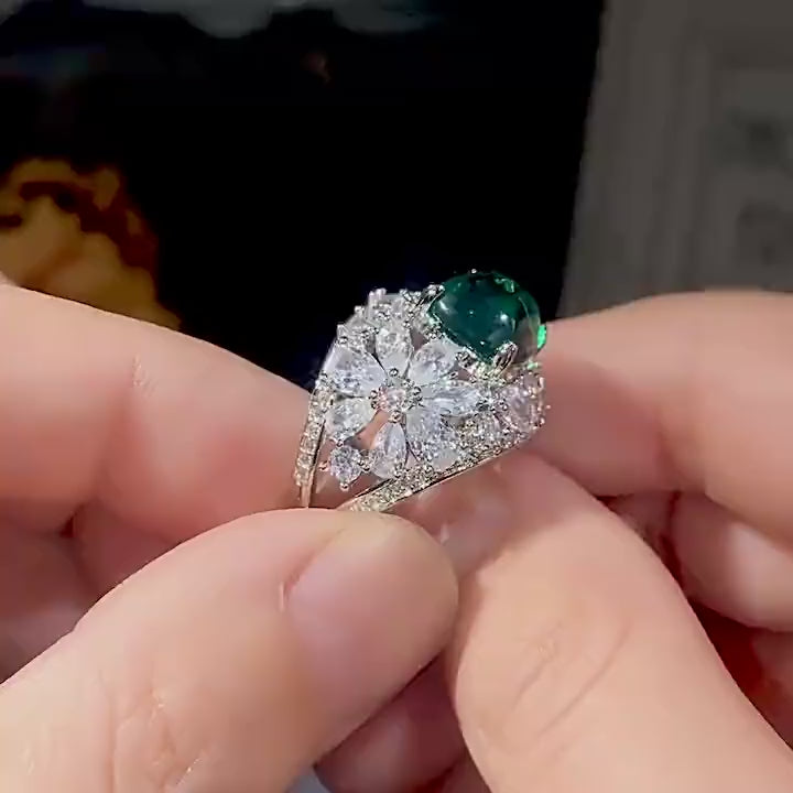 Floral design engagement ring with a green stone
